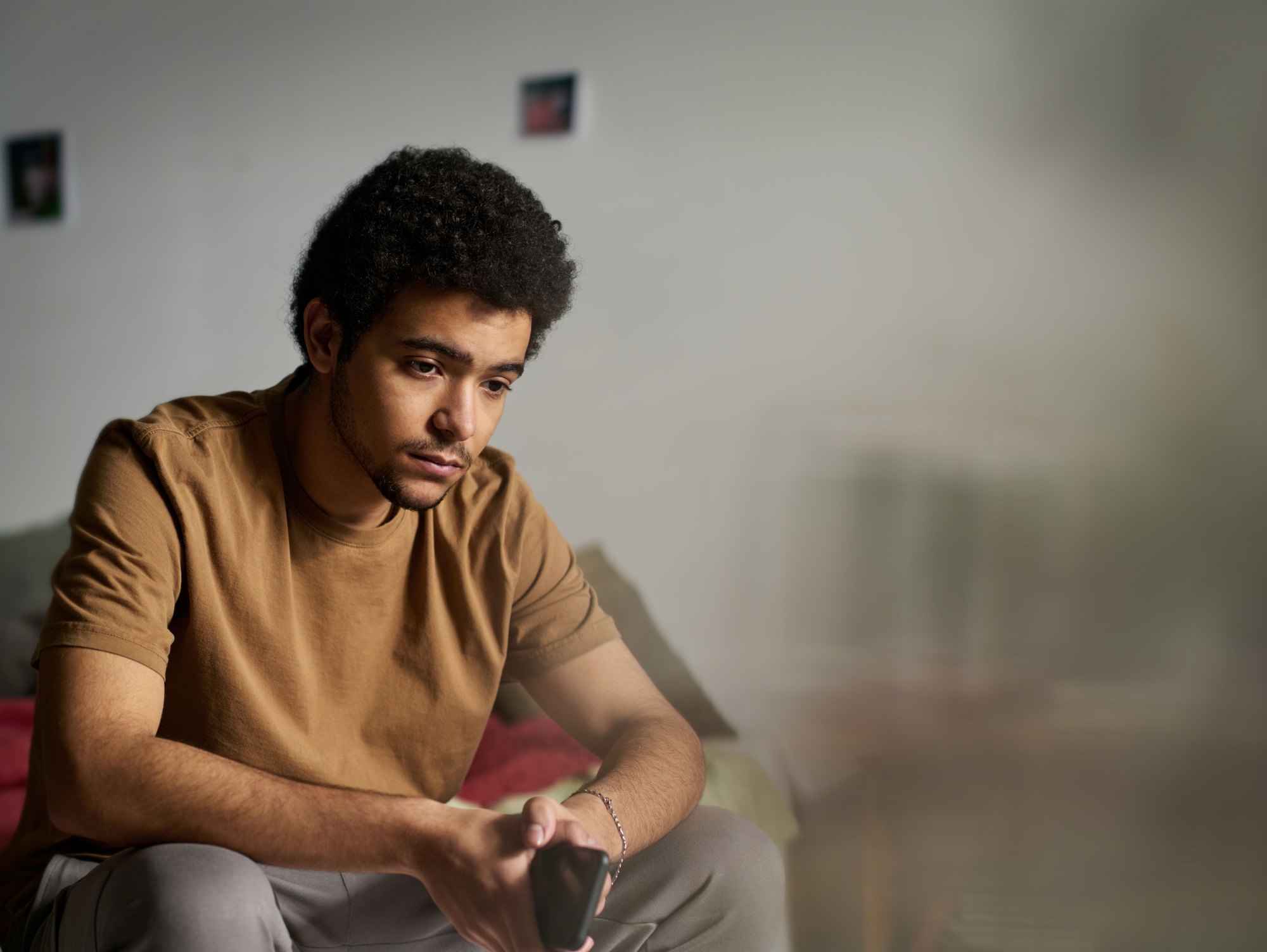 A young man sitting deep in thought
